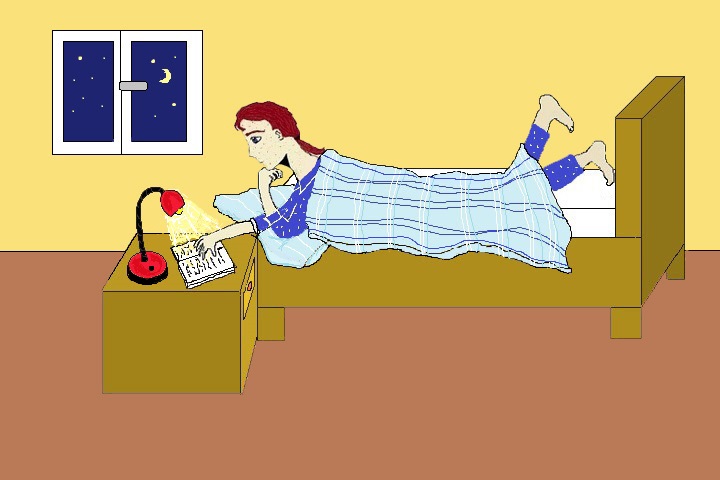 Junge liegt auf Bett und liest ein Buch